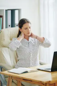 woman holding her neck 