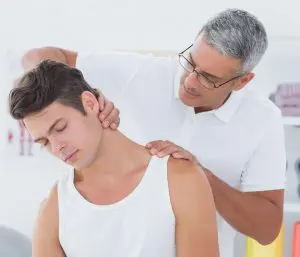 chiropractor stretching male patients neck