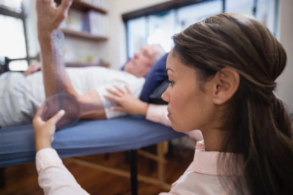 chiropractor examining patients elbow mobility 