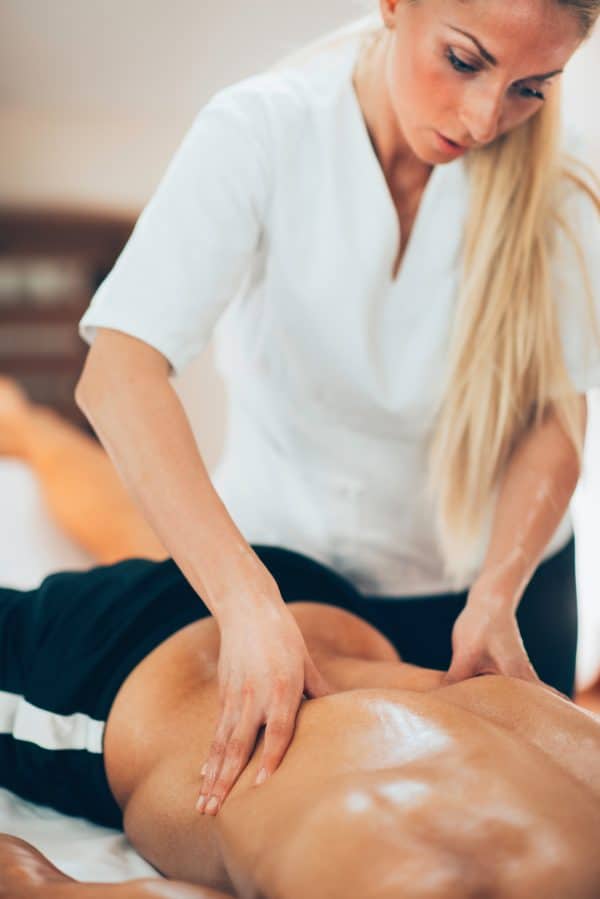 massage therapist massaging patient lower back