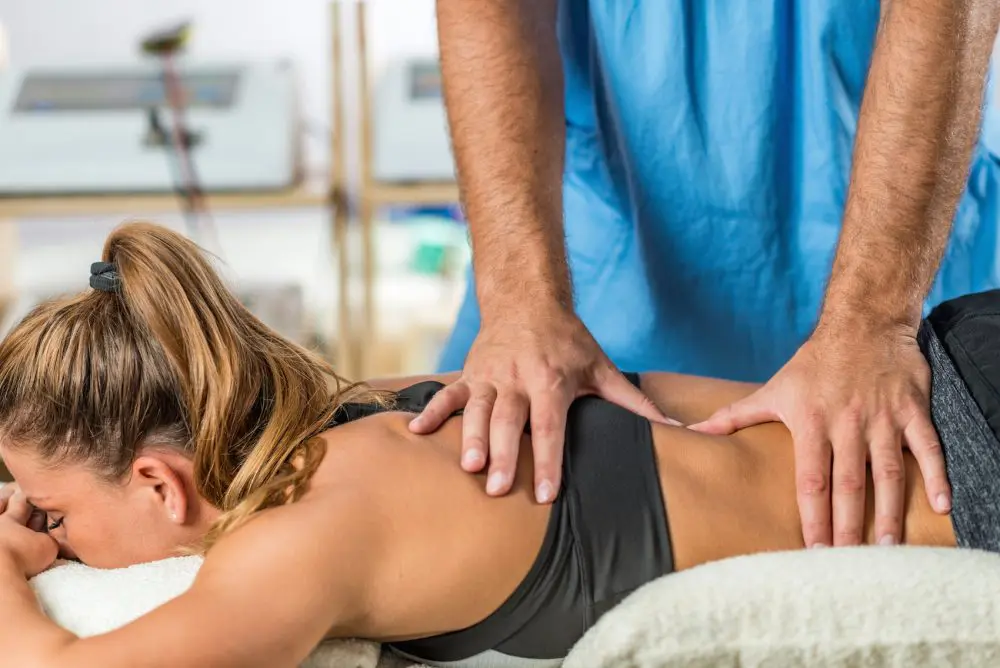 chiropractor adjusting female patients back