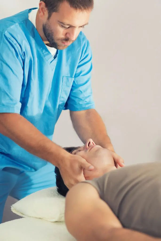 chiropractor adjusting patients neck for headache and migraine treatment in fort wayne