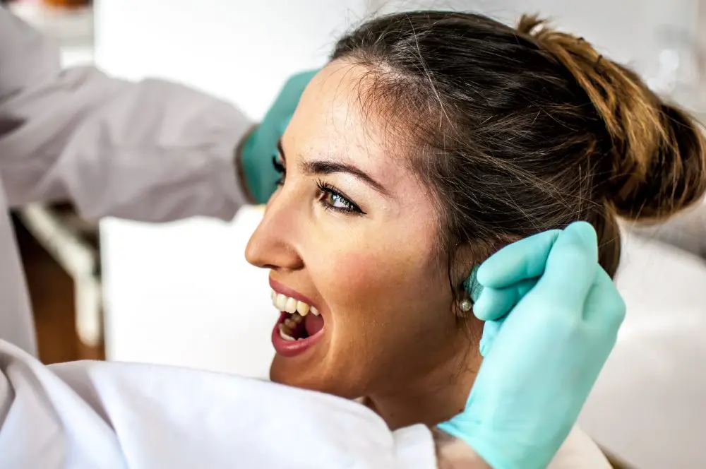 young lady getting examined by her doctor for tmj pain