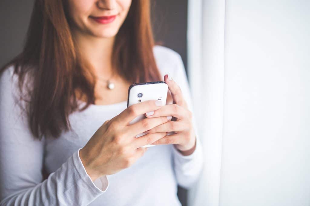 A woman making an appointment through her phone
