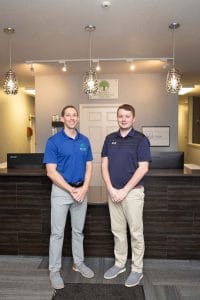 chiropractors of North East Chiropractic Center posing on their lobby