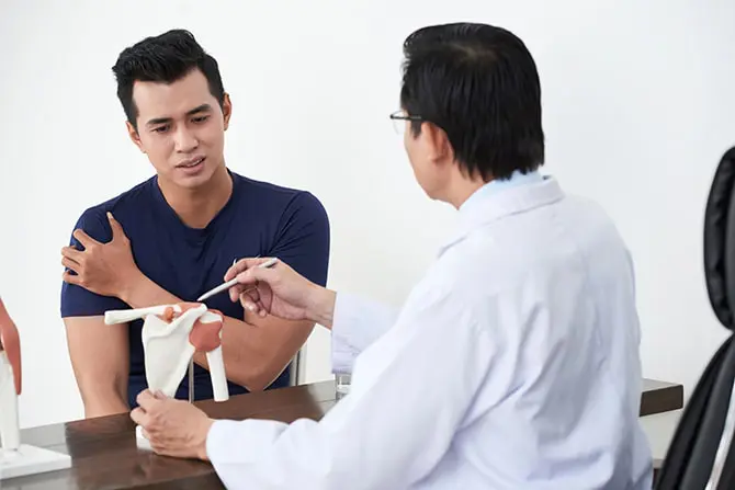 Male patient having a doctor's consultation for arm pain