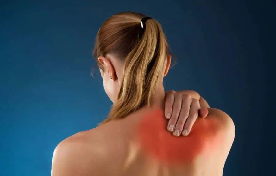 Woman touching his back due to pain from pinched nerve.
