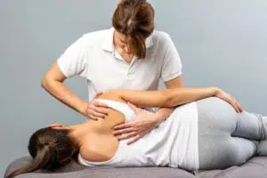 Female patient getting flexion distraction therapy by a chiropractor