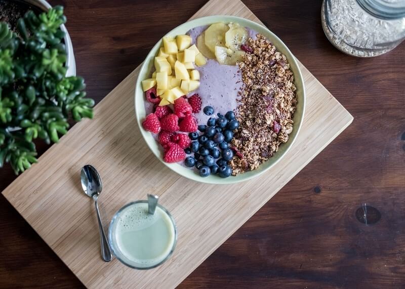 acai bowl and milk diet on a wood cutting board chiropractor recommended diet