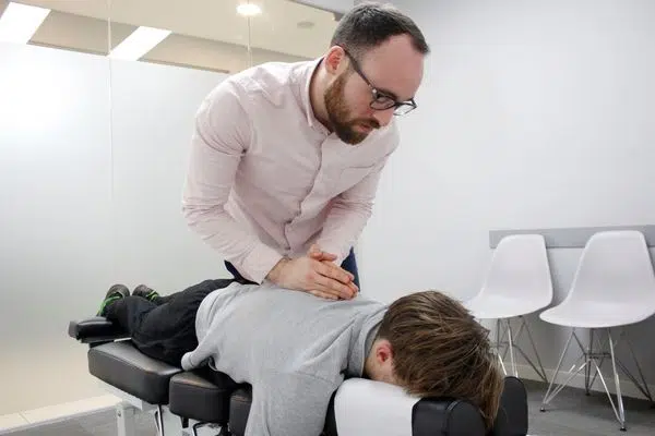 Chiropractor is doing the Thompson Drop Technique to the patient