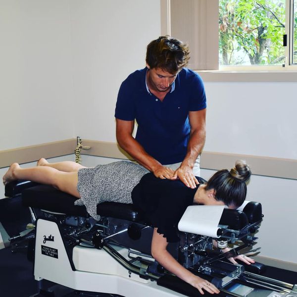 Chiropractor is doing the Thompson Drop Technique to the patient.