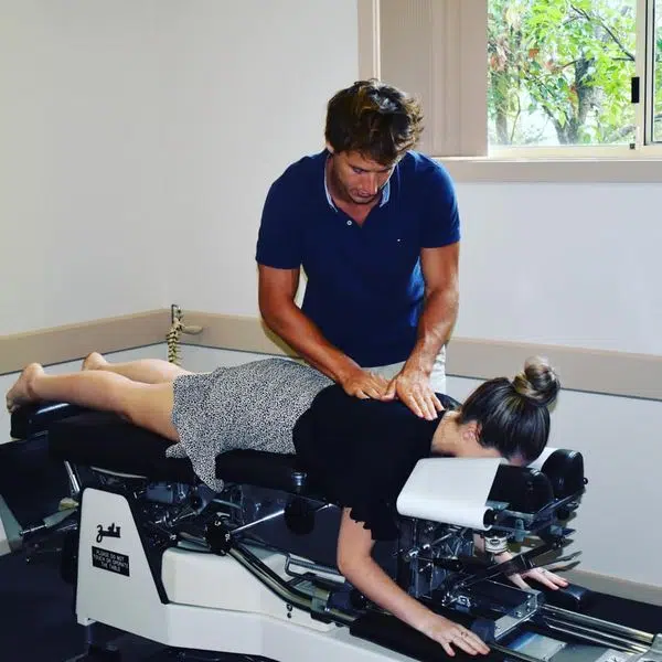 Chiropractor is doing the Thompson Drop Technique to the patient.