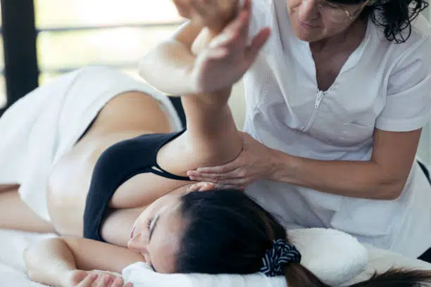 Pregnant woman is having a prenatal massage in a chiropractic clinic