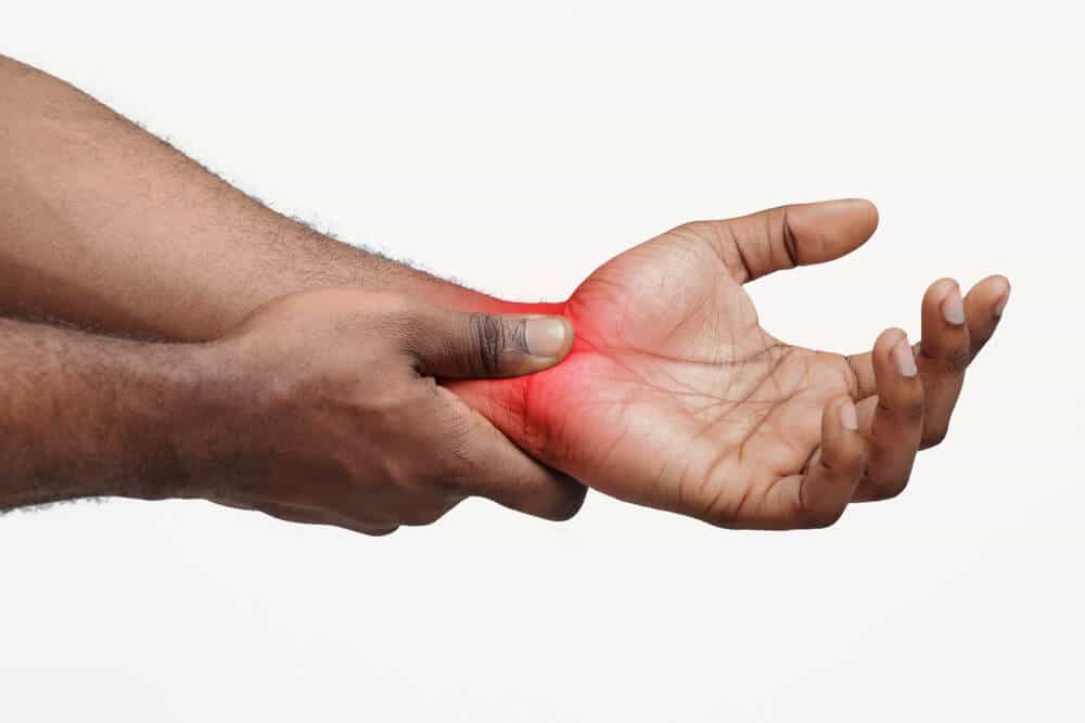 A mans hand with highlighted red pain in the hands.