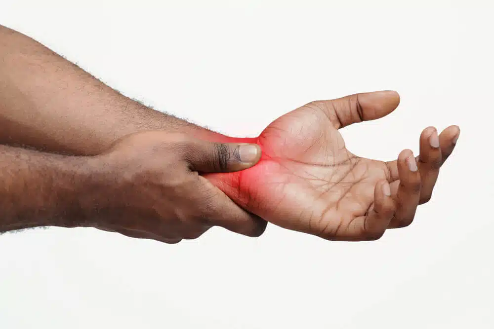 A mans hand with highlighted red pain in the hands.