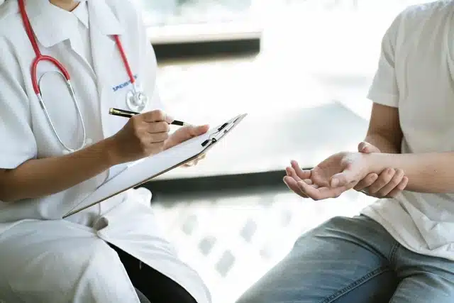 Chiropractor checks the patients wrist cause by carpal tunnel syndrome.