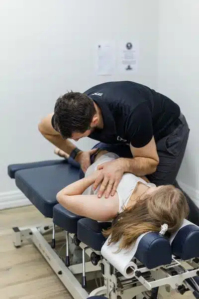 Chiropractor is doing some chiropractic adjustment to the patient.