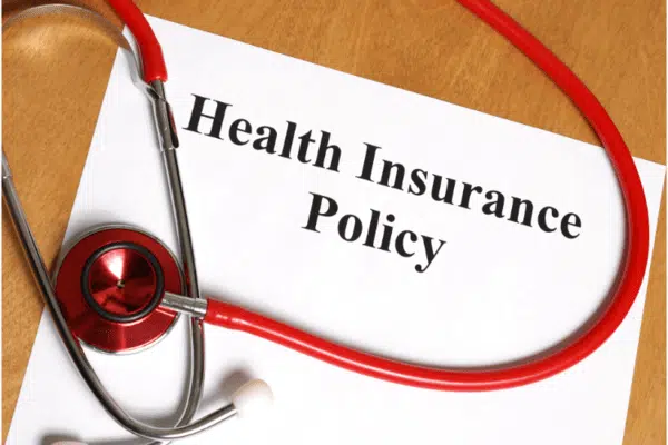 Health insurance plan and policy documents on the table.