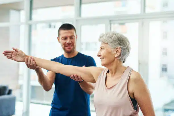 male chiropractor working with a senior female patient