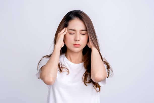 Young asian woman with hand on head for pain in head because stress. Suffering migraine.