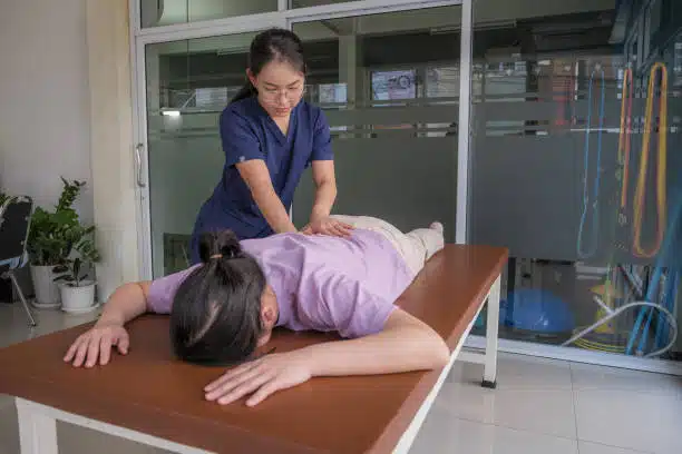 Chiropractor doing some Spinal adjustment to the patient.
