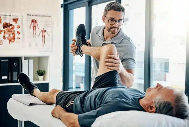 Shot of a friendly physiotherapist treating his mature patient in a rehabilitation center.