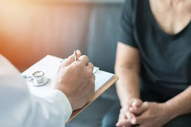 Chiropractor is having a consultation with a patient at the clinic.