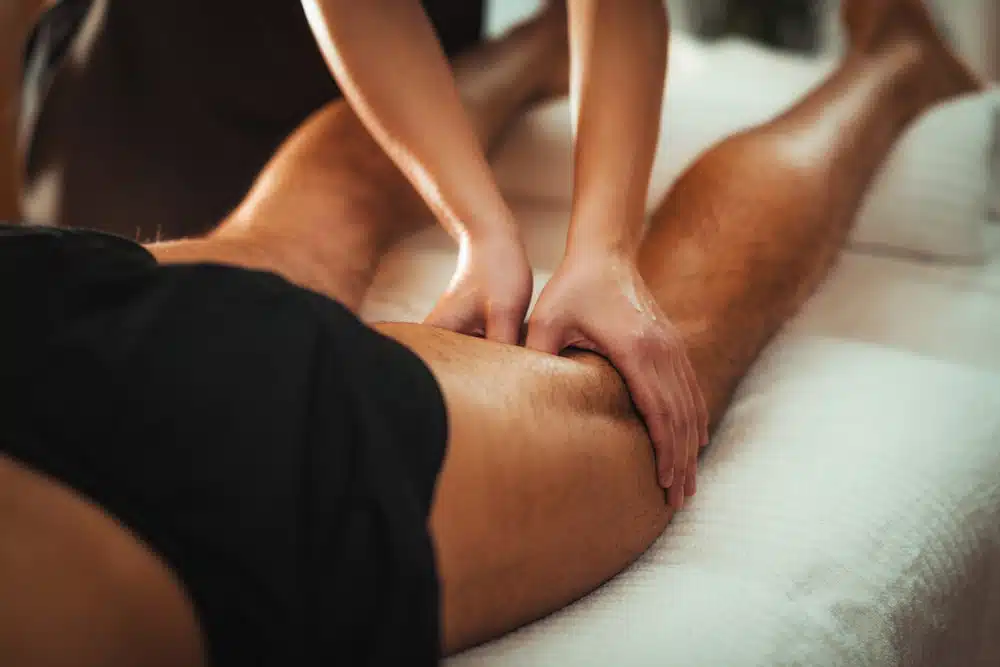 Leg sports massage therapy for patient with injury.