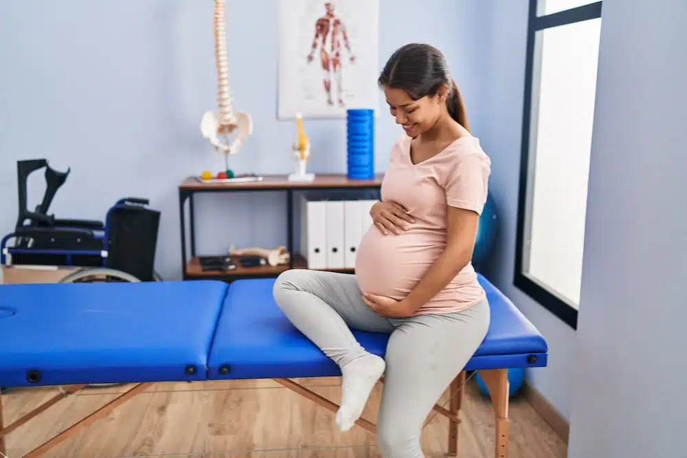 Pregnant woman having her prenatal chiropractic treatment at the clinic.