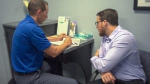 Dr. Adam Osenga explaining the process of Spinal decompression to the patient