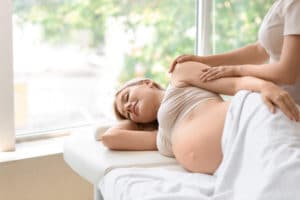 Pregnant woman getting prenatal chiropractic care.
