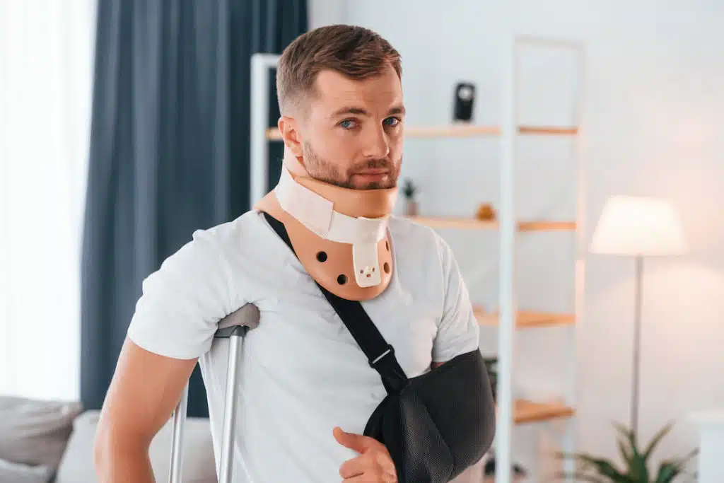 man with crutches indoors after getting personal injury