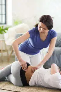 chiropractor doing spinal adjustment on female patient for personal injury treatment in Fort Wayne