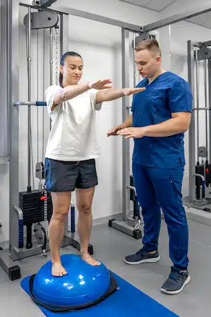 physical therapist working with a girl at the clinic after acquiring auto accident injury | auto accident injury treatment in Fort Wayne