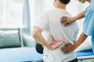 man receiving regular chiropractic adjustments for chronic back pain focus on long-term spinal health and functionality | acute vs chronic back pain