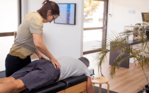 Senior man having a hip chiropractic adjustment in a chiropractic clinic