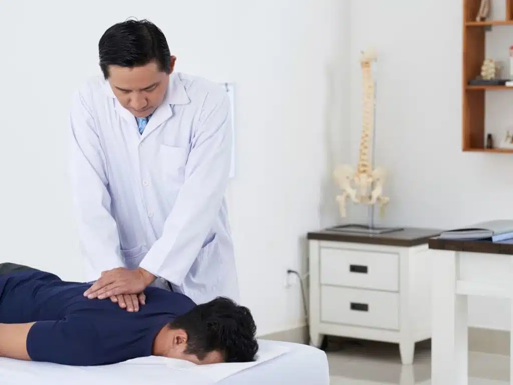 chiropractor adjusting spine