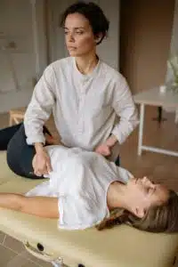 chiropractor doing hip adjustment on female patient