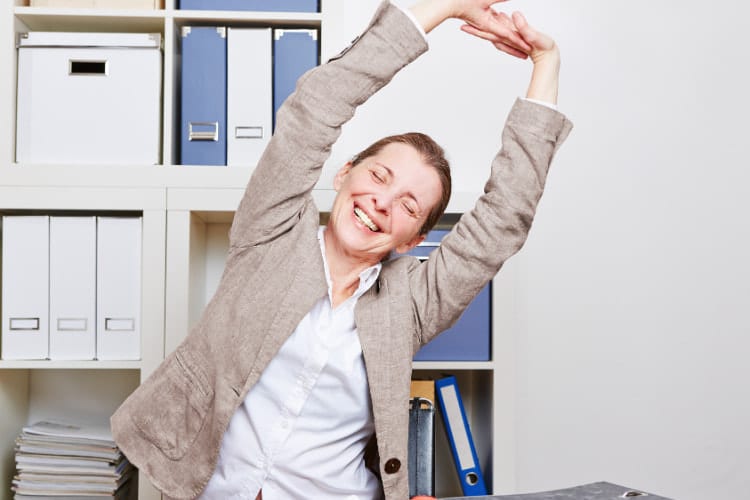 Office worker stretching to reset posture and reduce back tension